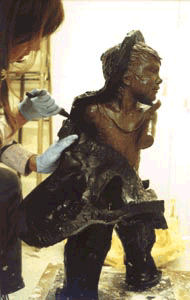 Cutting a rubber mold off the clay model