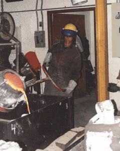 Pouring molten cronze into a silica mold